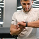 Man checking smartwatch in a gym